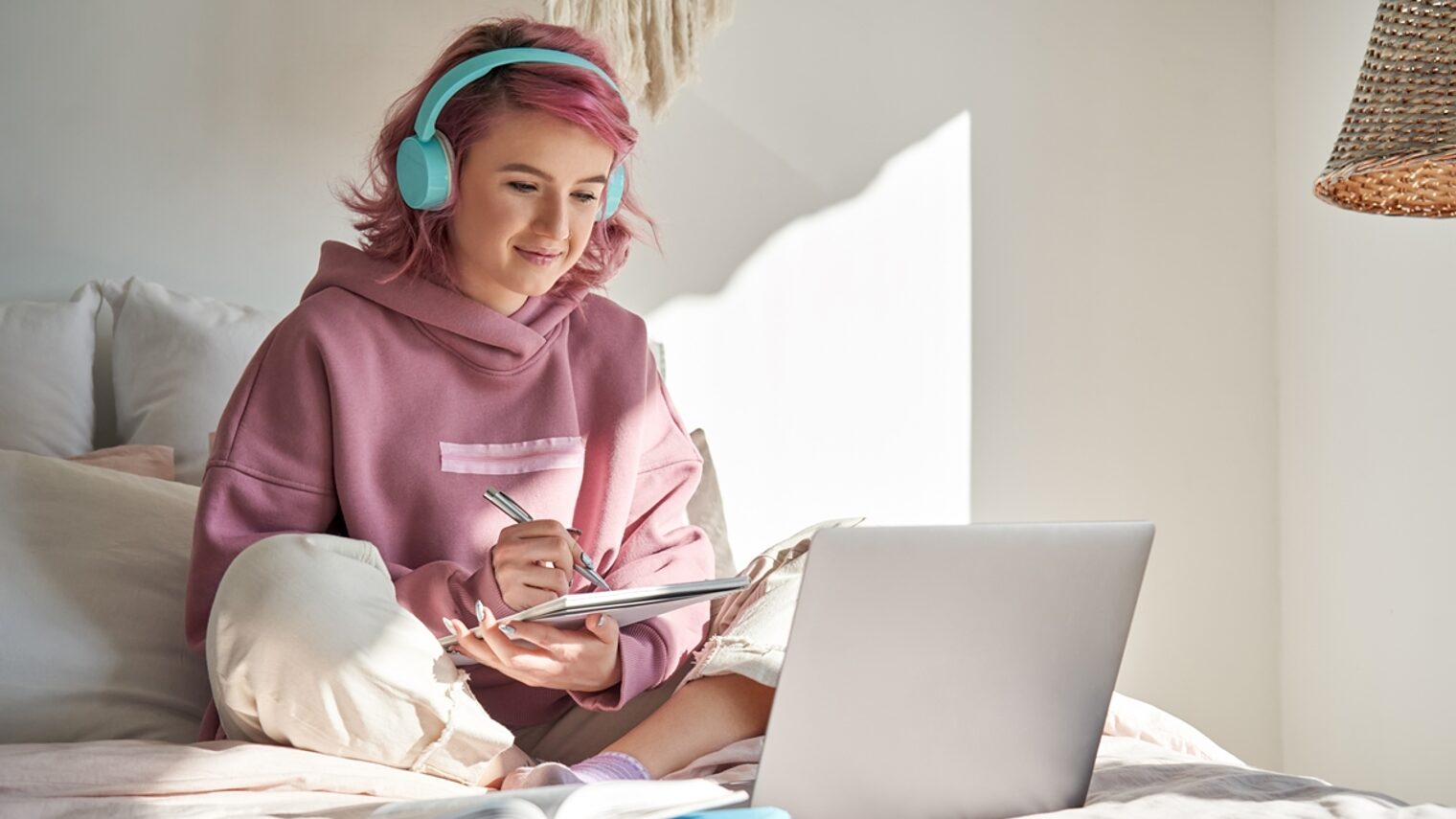 Mädchen mit Kopfhörer arbeitet mit Laptop